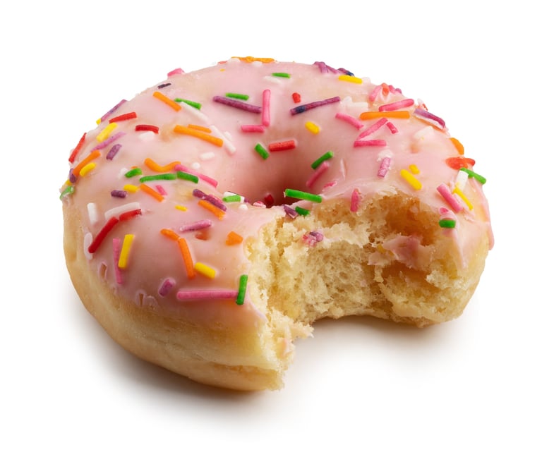 Pink glazed protein donut closeup on white background